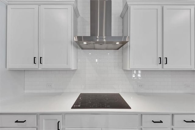 212 Birchwood Row, Canton, GA 30115 - kitchen with wall chimney range hood, black electric cooktop, light countertops, and decorative backsplash