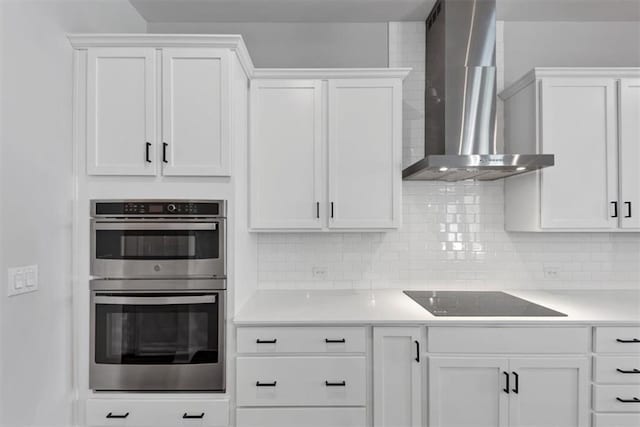 212 Birchwood Row, Canton, GA 30115 - kitchen with wall chimney exhaust hood, black electric stovetop, stainless steel double oven, and white cabinets