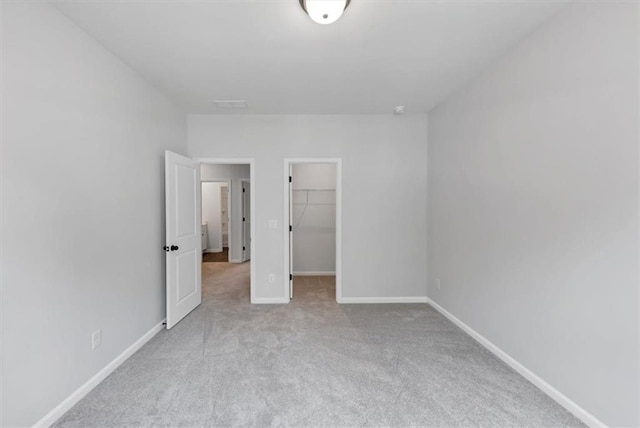 212 Birchwood Row, Canton, GA 30115 - unfurnished bedroom featuring carpet floors, a spacious closet, baseboards, and a closet
