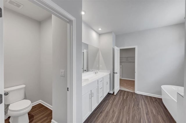 212 Birchwood Row, Canton, GA 30115 - full bathroom with wood finished floors, toilet, a freestanding tub, baseboards, and double vanity