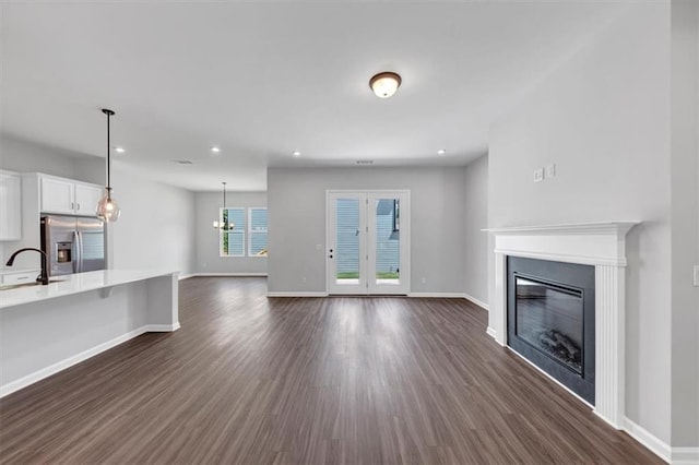212 Birchwood Row, Canton, GA 30115 - unfurnished living room with a glass covered fireplace, dark wood-style floors, baseboards, and recessed lighting