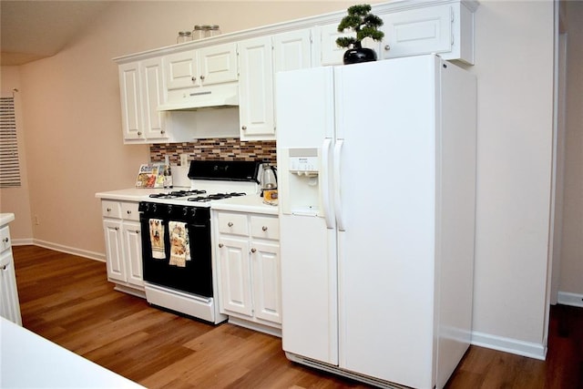 kitchen featuring hardwood / wood-style flooring, white appliances, and white cabinets