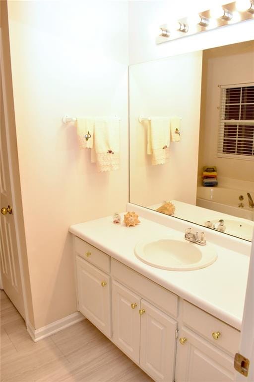 bathroom with vanity and a tub