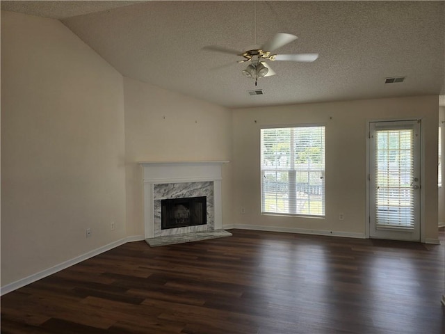 unfurnished living room featuring ceiling fan, a textured ceiling, dark wood-type flooring, and vaulted ceiling