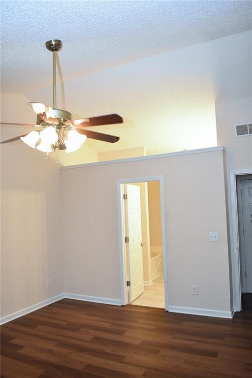 spare room featuring a textured ceiling, dark wood-type flooring, and ceiling fan