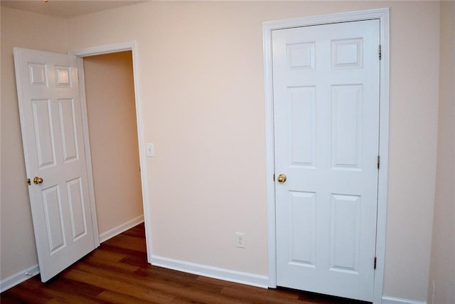 unfurnished bedroom featuring dark hardwood / wood-style flooring