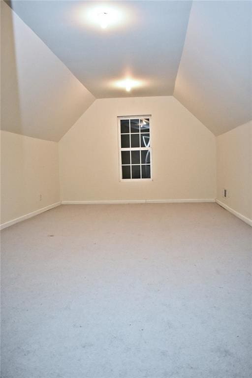 bonus room with lofted ceiling and carpet floors