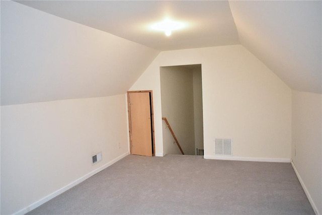 bonus room with carpet floors and vaulted ceiling