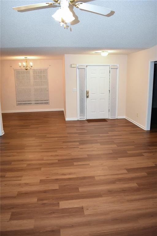 foyer with a textured ceiling, ceiling fan with notable chandelier, and hardwood / wood-style flooring