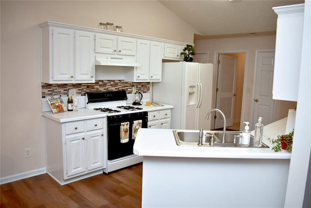 kitchen featuring decorative backsplash, white cabinets, white appliances, dark hardwood / wood-style floors, and sink