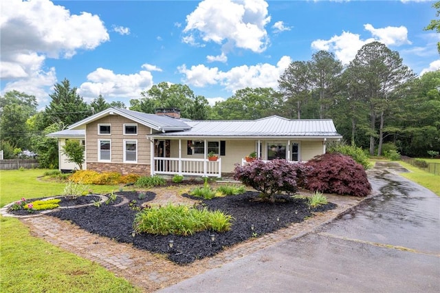 191 Durham St, Dallas, GA 30132 - ranch-style home featuring a porch, stone siding, metal roof, and a front yard