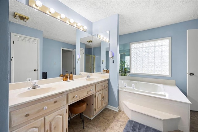 191 Durham St, Dallas, GA 30132 - full bath featuring a garden tub, double vanity, a stall shower, and a textured ceiling