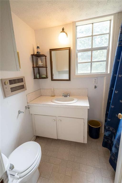 1434 Culpepper Rd, Calhoun, GA 30701 - bathroom featuring vanity, heating unit, and a textured ceiling