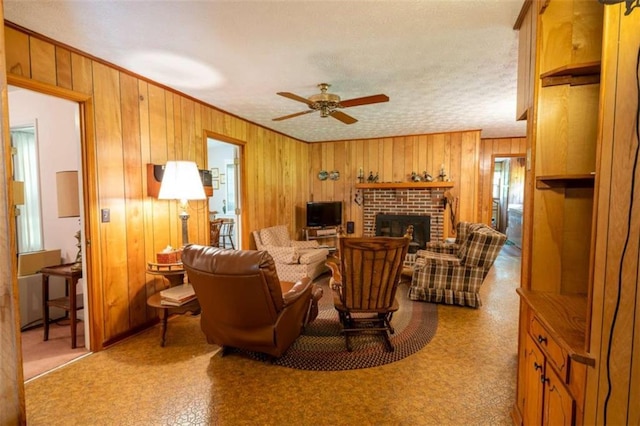 1434 Culpepper Rd, Calhoun, GA 30701 - living area featuring wooden walls, ceiling fan, a brick fireplace, a textured ceiling, and ornamental molding