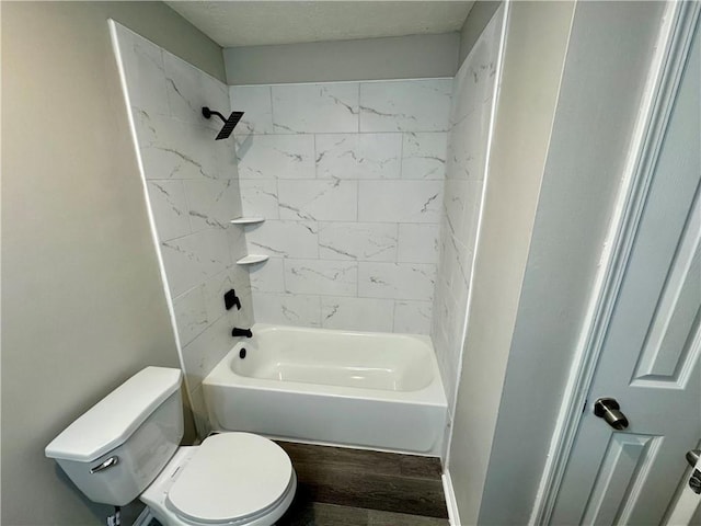 bathroom featuring wood finished floors, toilet, and shower / washtub combination