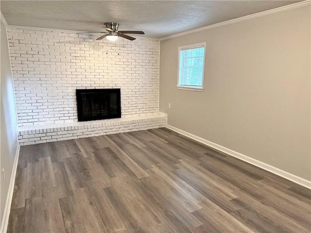 unfurnished living room with a fireplace, a ceiling fan, baseboards, ornamental molding, and wood finished floors