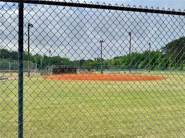 view of tennis court featuring fence