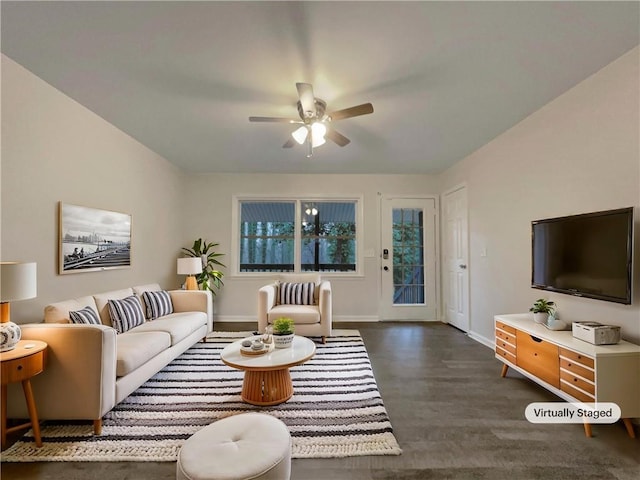 living room featuring dark hardwood / wood-style flooring and ceiling fan