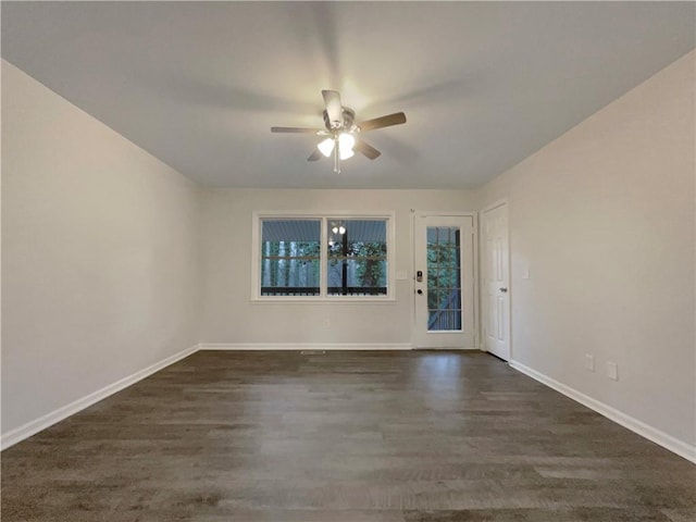 empty room featuring dark hardwood / wood-style floors and ceiling fan