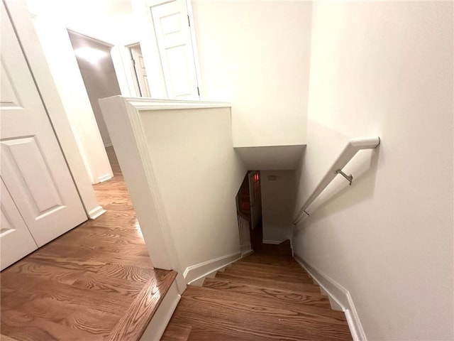 stairway featuring baseboards and wood finished floors