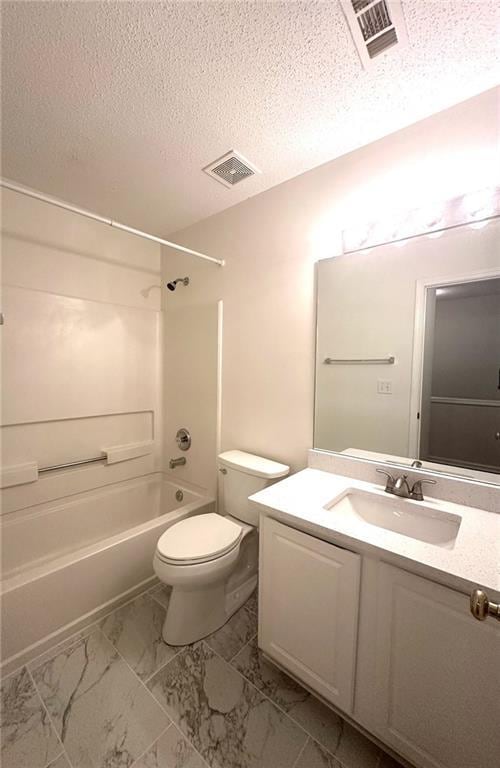 full bathroom featuring visible vents, tub / shower combination, toilet, vanity, and a textured ceiling