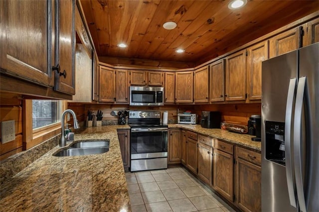 kitchen featuring light stone counters, wooden ceiling, light tile patterned flooring, stainless steel appliances, and a sink