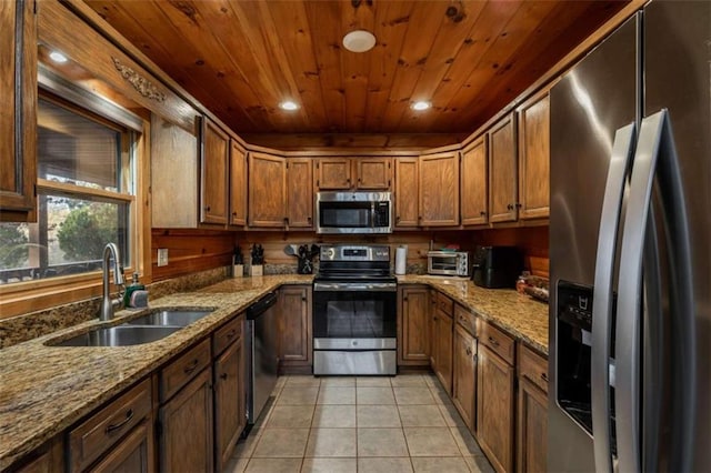 kitchen with light tile patterned floors, brown cabinets, wooden ceiling, stainless steel appliances, and a sink