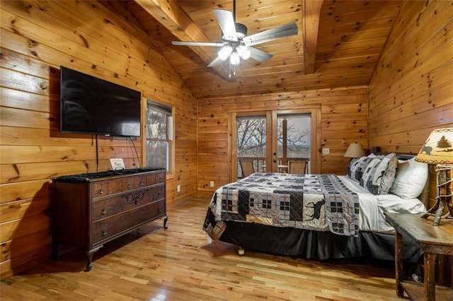 bedroom featuring light wood-type flooring, multiple windows, lofted ceiling, and access to outside