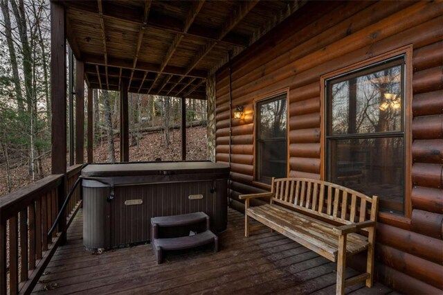 wooden terrace featuring a hot tub