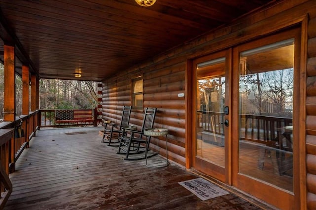 wooden deck featuring a porch and visible vents