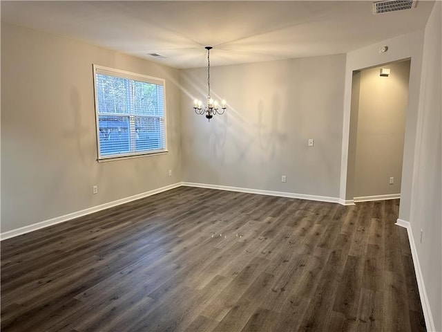 unfurnished dining area with dark hardwood / wood-style floors and a notable chandelier