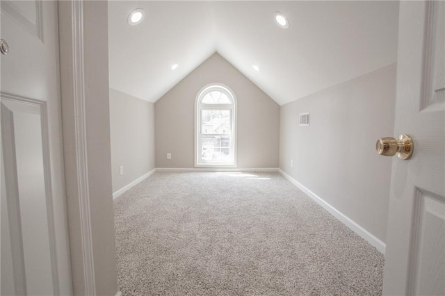 bonus room with vaulted ceiling, carpet, visible vents, and baseboards