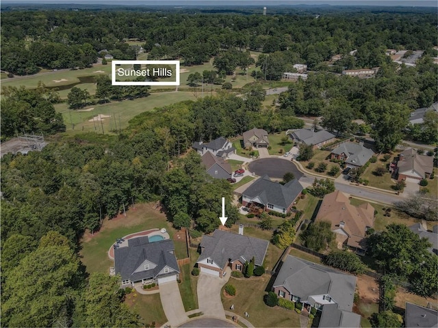 birds eye view of property featuring a residential view and a wooded view