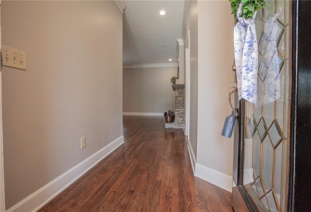 hallway featuring crown molding, baseboards, wood finished floors, and recessed lighting