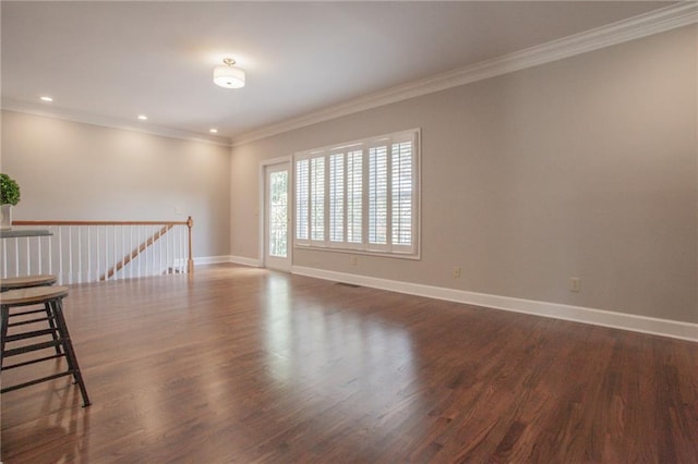 spare room featuring recessed lighting, baseboards, crown molding, and wood finished floors