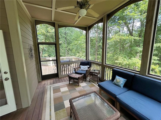 sunroom / solarium featuring a ceiling fan