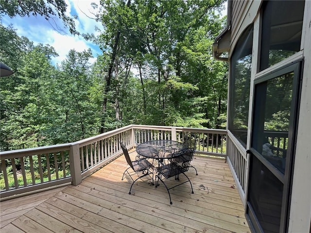 wooden terrace with outdoor dining area