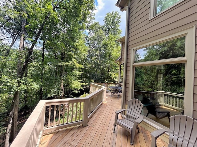 wooden terrace with outdoor dining space