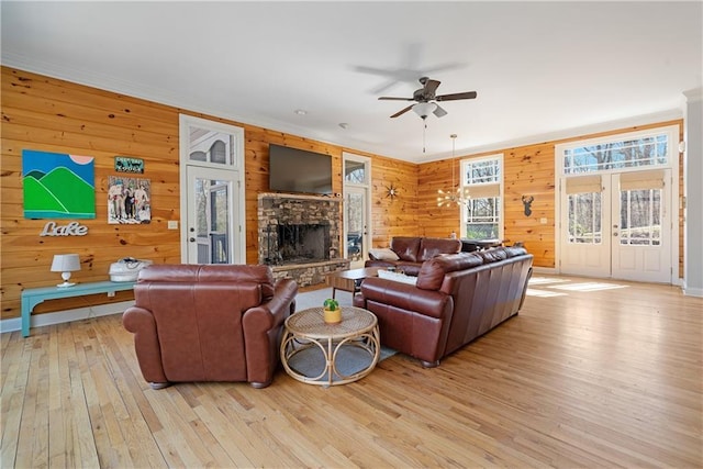 57 Shaggy Maple Ln, Big Canoe, GA 30143 - living room featuring wood-type flooring, a ceiling fan, french doors, wooden walls, and ornamental molding