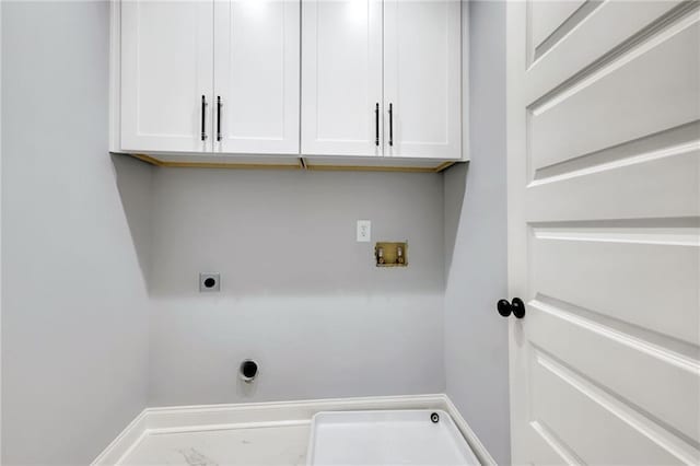 laundry area with hookup for an electric dryer, washer hookup, baseboards, marble finish floor, and cabinet space