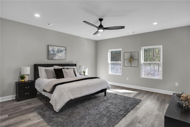 bedroom featuring recessed lighting, wood finished floors, visible vents, and baseboards