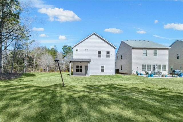 rear view of property with a lawn and a patio