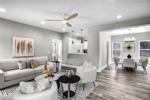 living area featuring recessed lighting, wood finished floors, and baseboards