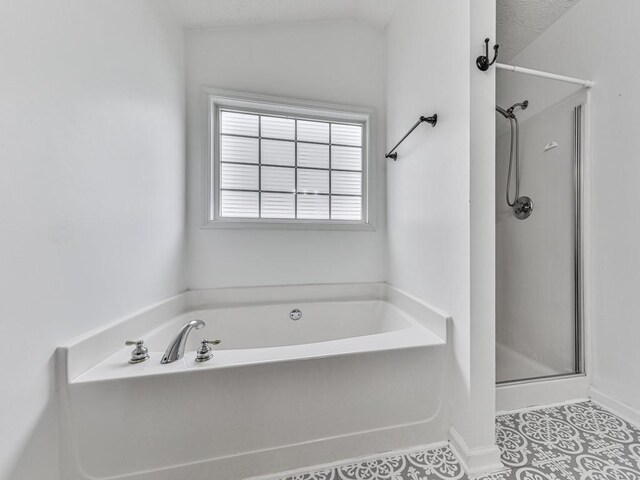 bathroom featuring tile patterned floors, a textured ceiling, vaulted ceiling, and separate shower and tub