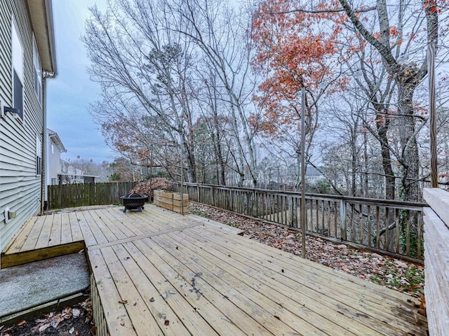 wooden deck featuring an outdoor fire pit