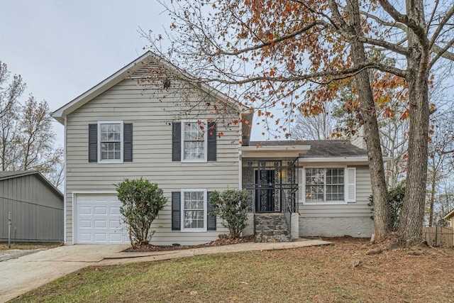 tri-level home featuring a garage and concrete driveway