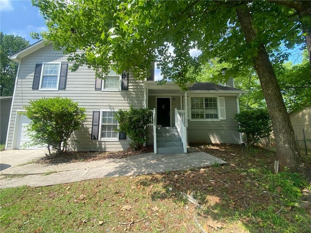 tri-level home with a garage and fence