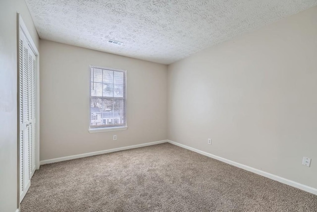 unfurnished bedroom featuring carpet, a closet, visible vents, and baseboards