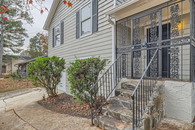 view of exterior entry with driveway and a garage