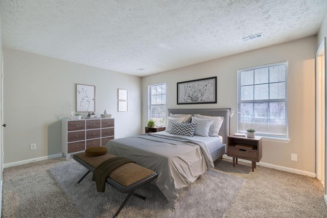 bedroom featuring carpet, visible vents, and baseboards